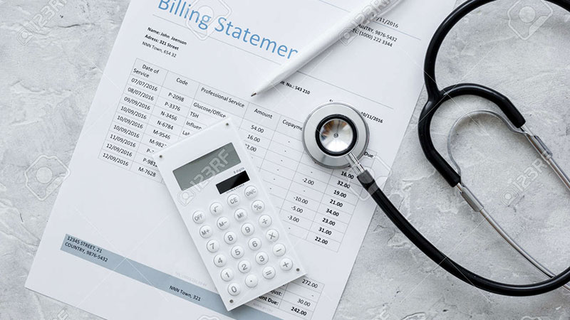 Billing statement with calculator and stethoscope
