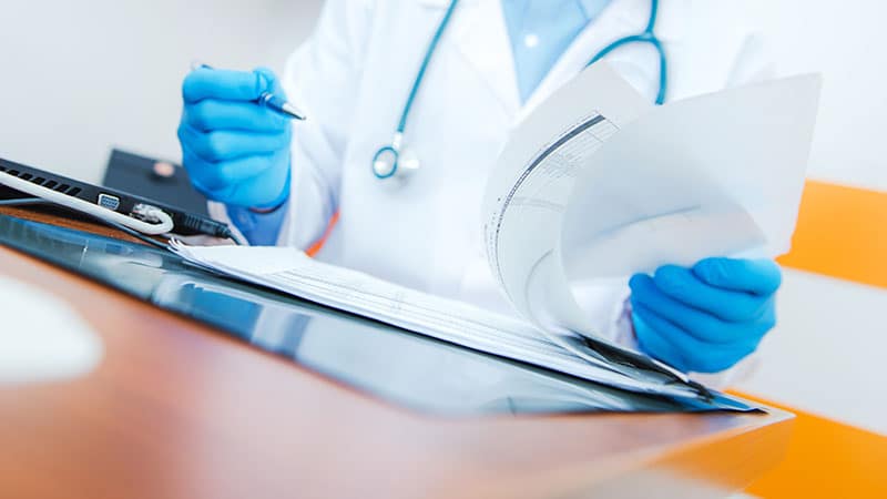 Doctor looking over patient files